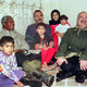 United Nations Secretary General Kofi Annan (L) and Jordan's Crown Prince Hassan (R ) meet with a Palestinian family during their tour at Hitteen Palestinian refugee camp near Amman March 18. Annan on the first leg of a nine-day tour of the Middle East is expected to discuss latest regional developments with its leaders.